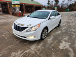 2011 Hyundai Sonata in white color parked at a gas station, featuring a turbocharged engine and automatic transmission.