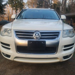 Front view of a 2010 Volkswagen Touareg with 113,000 miles, showcasing its modern design and features.