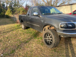 2002 Ford F150 truck with small lift and panther rims, needs work and has transmission issues