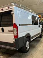 2017 Ram Promaster 1500, bright white exterior, featuring exterior ladder rack and cargo shelving.