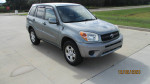 2004 Toyota RAV4 in silver, one owner, well-maintained with new tires and battery, parked on a driveway.