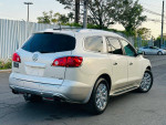 2011 Buick Enclave CXL2 FWD in silver with chrome wheels and tinted windows parked on the street