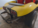 Rear view of a yellow 1970 Volkswagen Dune Buggy with racing seats and custom electric wiring.