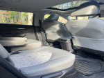 Interior view of a 2023 Toyota Highlander showing comfortable gray seats and ample cargo space.