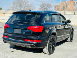 2013 Audi Q7 3.0T Premium Plus quattro in black, showcasing its sleek rear design and alloy wheels.