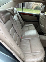 Interior view of a 2003 Lexus GS 300 with clean heated leather seats and spacious rear seating.
