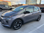 2023 Chevrolet Bolt 2LT in Gray Ghost Metallic parked outside, showcasing its sleek design and modern features.