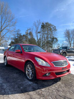 2010 Infiniti G37x AWD in red parked outside under clear blue sky, showcasing sporty design and clean condition.