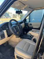 Interior view of a 2006 Land Rover LR3 with black and beige leather seats and dashboard
