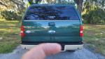 Rear view of a green 2008 Ford F150 King Ranch 4x4 truck with a clean title