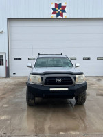 Front view of a 2005 Toyota Tacoma truck with a light bar, 89,000 miles, for sale.