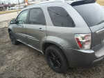 2005 Chevrolet Equinox LT AWD in gray, featuring black rims and a clean exterior, parked on a gravel surface.