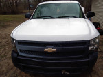 Front view of a 2008 Chevrolet Silverado 1500 Work Truck in white, showcasing its clean appearance and robust design.