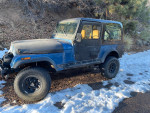 1985 Jeep CJ7 with Chevy 350 V8 engine, new parts, parked on snow-covered ground