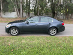 2011 Infiniti G25 x parked on a road, showcasing its sleek design and excellent condition.