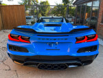 Rear view of a stunning 2023 Chevrolet Corvette Z06 in Rapid Blue, showcasing sleek design and luxury features.