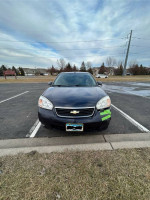 2006 Chevy Malibu LT in blue parked with minor front bumper damage and new tires.