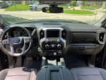 Interior view of a 2021 GMC Sierra 1500 Denali with modern dashboard and controls.