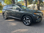 2024 Hyundai Tucson Limited AWD SUV parked on the street, showcasing a sleek design and modern features.