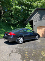 2007 Honda Accord EX-L Coupe parked in driveway with trees in background, showing minor cosmetic wear.