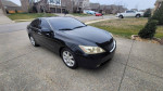 2007 Lexus ES 350 in black parked in residential area, showcasing its sleek design and well-kept condition.