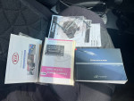 Owner's manuals and documents for a 2006 Kia Sportage inside the car