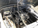 Engine compartment of a 1994 Jeep Wrangler with manual transmission and visible components.