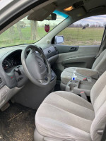 Interior view of a 2008 Kia Sedona van, featuring spacious seating for seven and a functional dashboard.