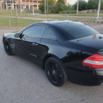 2008 Mercedes-Benz SL 550 in black with custom wheels parked outdoors.