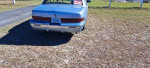 Rear view of a 1995 Buick Roadmaster for sale with 78,000 miles on a sunny day