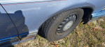 Close-up of the wheel and tire of a 1995 Buick Roadmaster showcasing its good condition and classic design.
