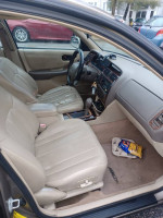 Interior view of a 1998 Toyota Avalon XLS showing beige seats and dashboard features