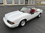 1992 Ford Mustang LX convertible in white with red interior, showcasing a sporty design and aftermarket modifications.