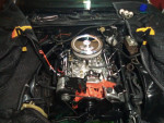 Engine bay of a 1980 Chevrolet Camaro showcasing the rebuilt V6 drivetrain with a 4-barrel carburetor.