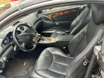 Interior of a 2008 Mercedes-Benz SL 550 convertible showing leather seats and dashboard details.