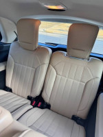 Rear seating area of a 2017 Mercedes-Benz GLS 450, showcasing clean beige leather upholstery.