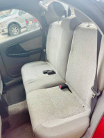 Interior view of the back seat in a 2003 Subaru Impreza Outback Sport with light gray upholstery.