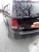 2006 Jeep Cherokee Laredo with clean title and all-wheel drive, showing a small ding on passenger corner.