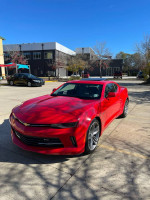 2018 Chevrolet Camaro 1LT Coupe RS in red, showcasing its sporty design and modern features, parked outdoors.