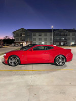 2018 Chevrolet Camaro 1LT Coupe in red, showcasing sleek design and RS Package features, parked at dusk.