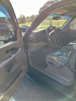 Interior view of a 2005 Chevrolet Suburban showing clean leather seats and dashboard.
