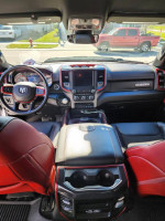 Interior view of a 2022 Ram Rebel extended cab truck showcasing premium features and red accents.