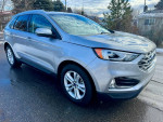 Side view of a 2020 Ford Edge SEL FWD in excellent condition with shiny exterior and clean wheels.