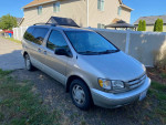 2000 Toyota Sienna XLE minivan parked outside, low mileage and maintained, ideal for family use.