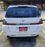 Back view of a 2007 Honda Odyssey minivan showcasing its sleek design and features.