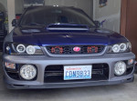 Front view of a 2001 Subaru Impreza with modifications, showcasing its sleek design and sporty features.