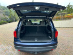 Interior view of 2016 Honda Pilot with spacious trunk area and gray leather seating