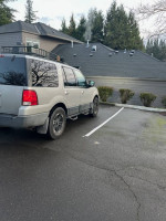 2003 Ford Expedition parked, featuring upgraded rims, 4x4 capability, and spacious interior for adventures.