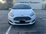 Front view of a 2015 Ford Fiesta, 83,000 miles, in good condition with clean interior and functional features.
