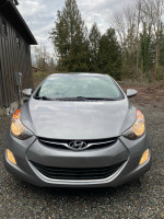 2013 Hyundai Elantra GLS in gray, showcasing a well-maintained exterior and headlights on